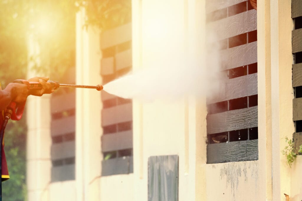 man power washing wooden decoration