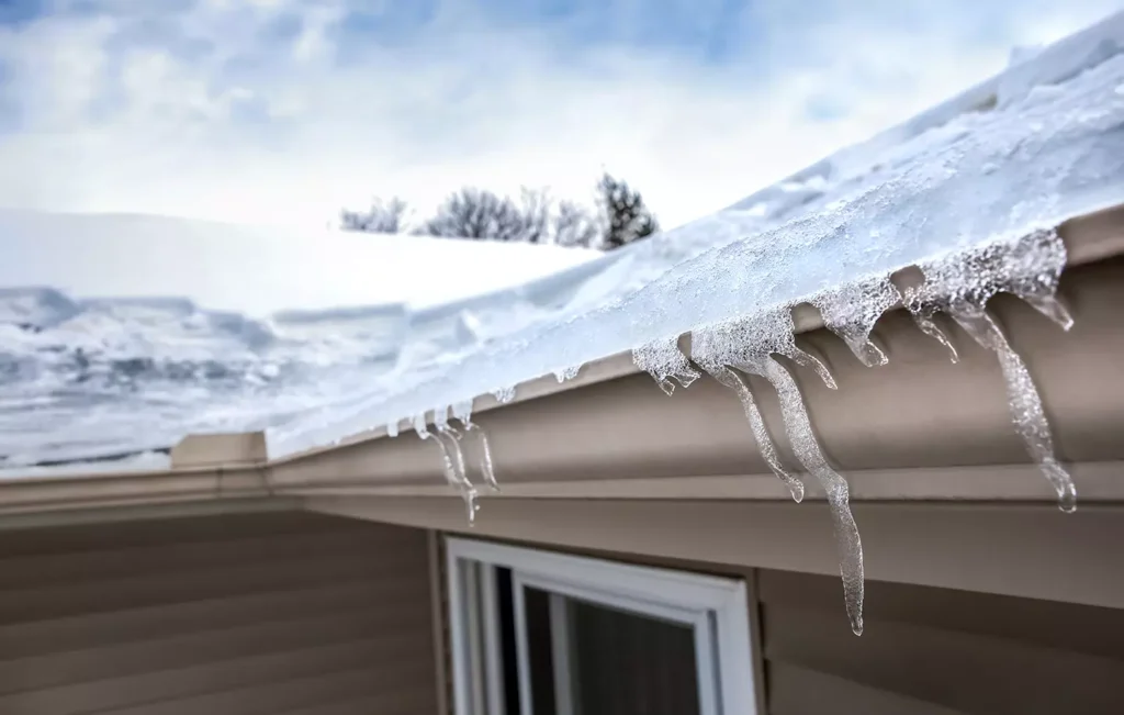 ice dams forming in clogged gutter