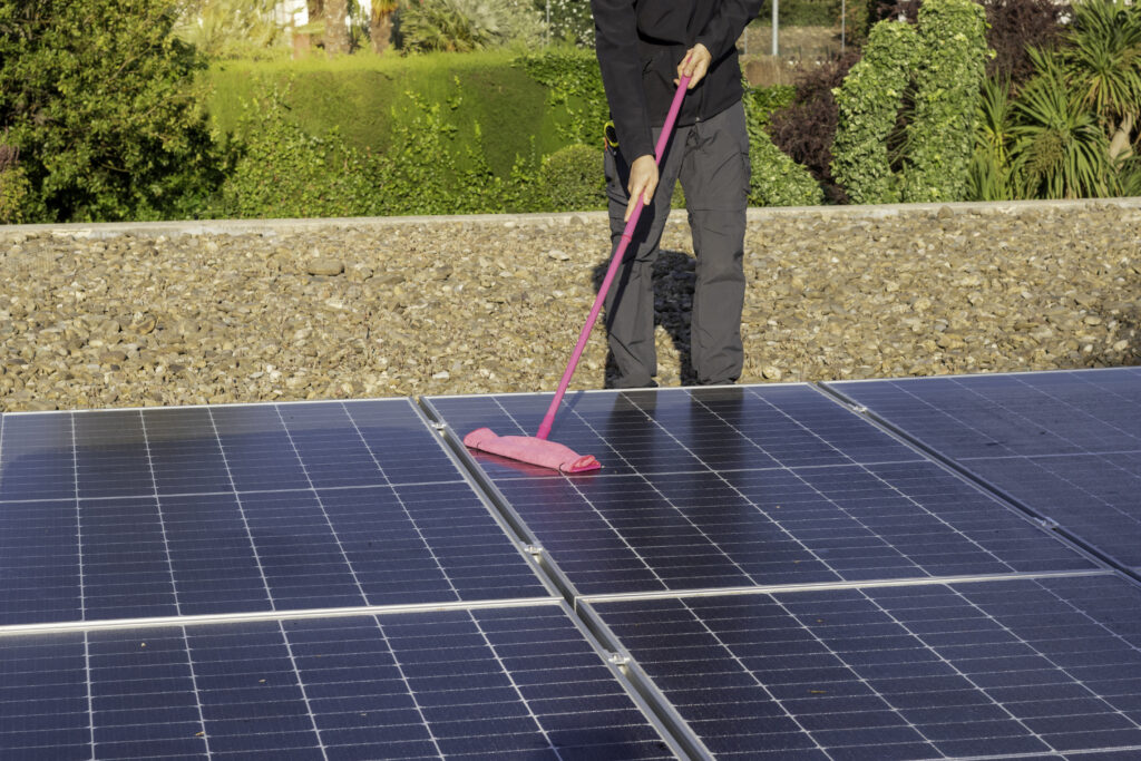 man cleaning his panels