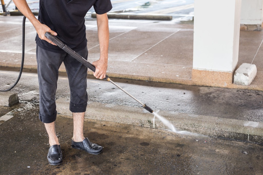 person washing driveway